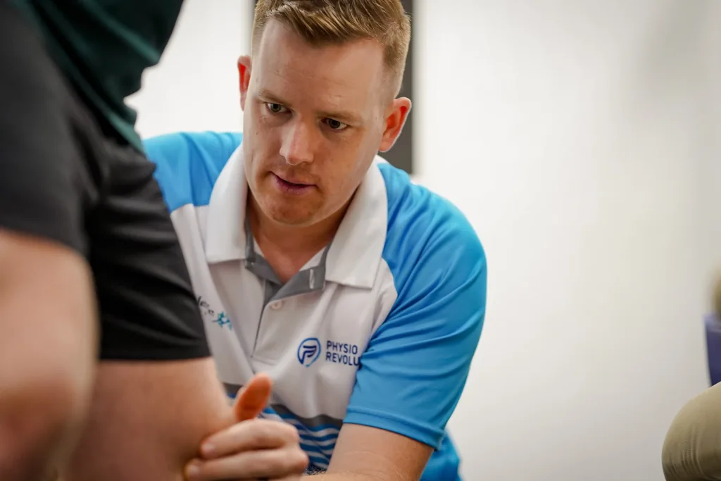 Physio Matt Beavis, treating a patients knee pain.